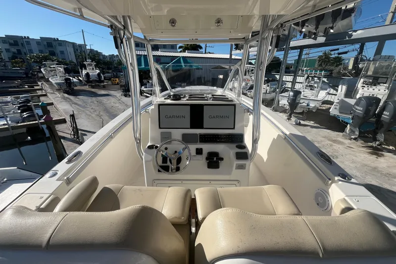 Slide: The Image of 2017 Cobia 277 Center Console boat with Garmin navigation, docked at a marina. - 10