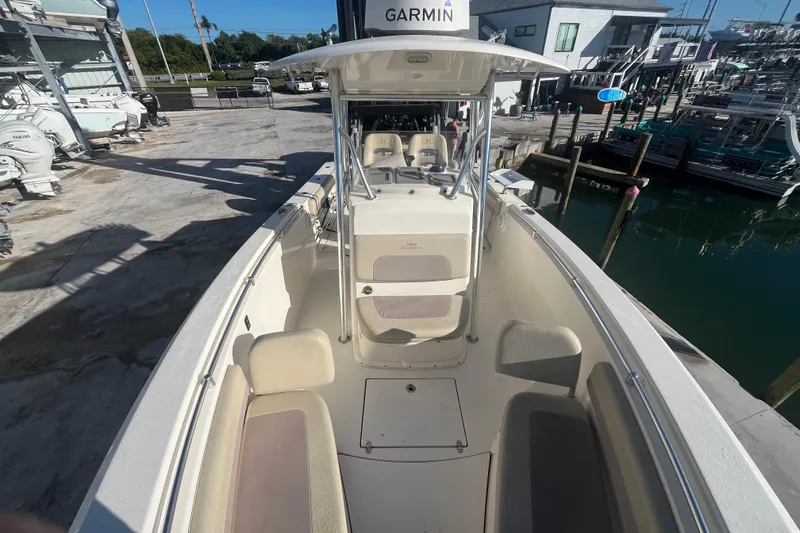 Slide: The Image of 2017 Cobia 277 Center Console boat docked, featuring spacious seating and Garmin equipment. - 14