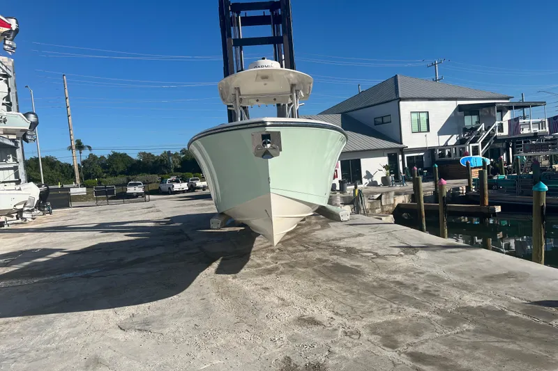 Slide: The Image of 2017 Cobia 277 Center Console boat on dock, sunny day, waterfront property. - 4
