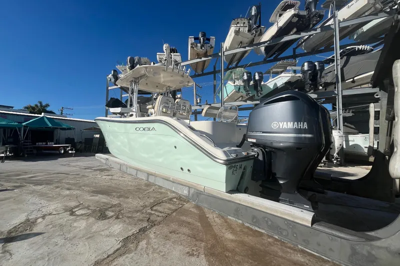 Slide: The Image of 2017 Cobia 277 Center Console boat with Yamaha engine in storage facility. - 5