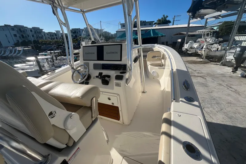 Slide: The Image of 2017 Cobia 277 Center Console boat with Garmin displays at a marina. - 8