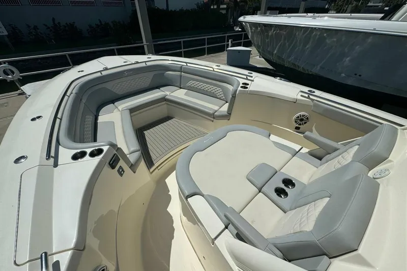 Slide: The Image of Luxurious seating area on a 2021 Scout 330 LXF boat, featuring elegant upholstery. - 11