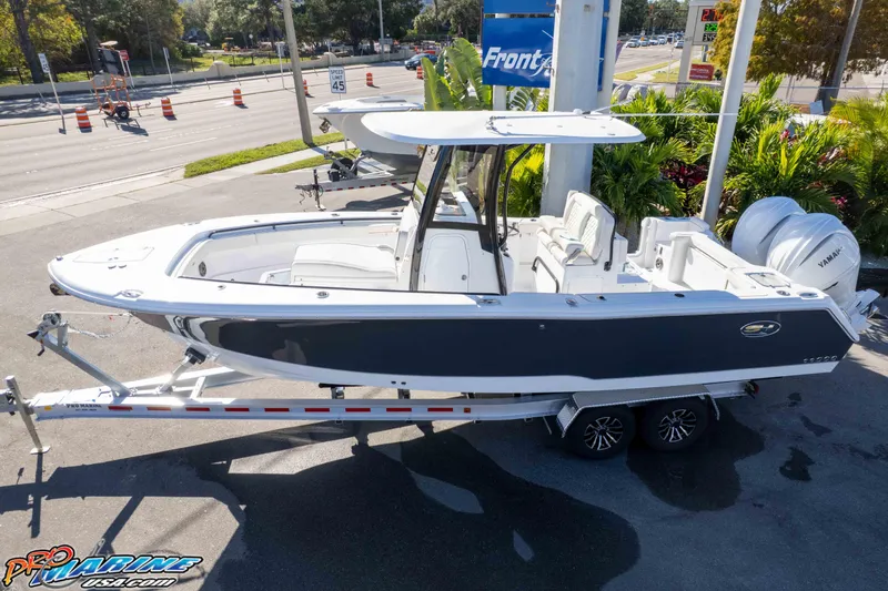 Slide: The Image of 2026 Sea Hunt Gamefish 27 Coffin Box boat on trailer, parked outdoors. - 10