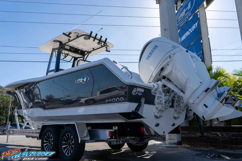 Slide: The Image of 2026 Sea Hunt Gamefish 27 Coffin Box boat with Yamaha engine on trailer. - 11