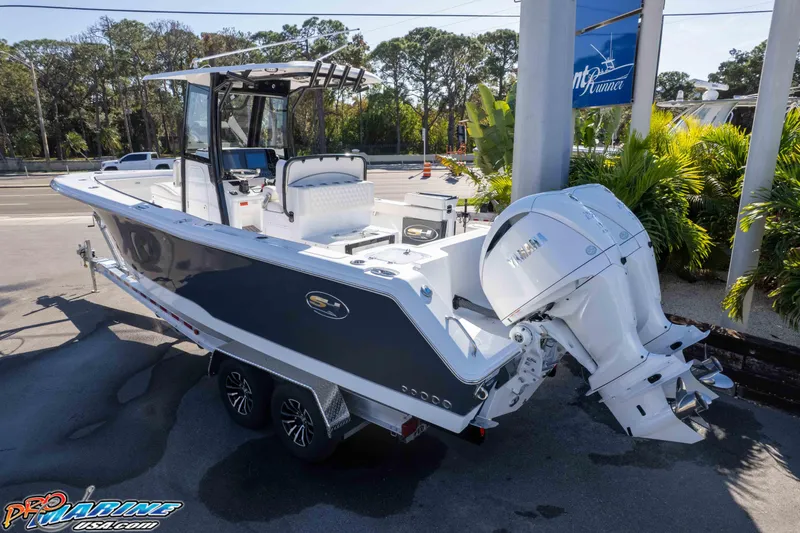 Slide: The Image of 2026 Sea Hunt Gamefish 27 Coffin Box boat with dual engines on a trailer. - 14