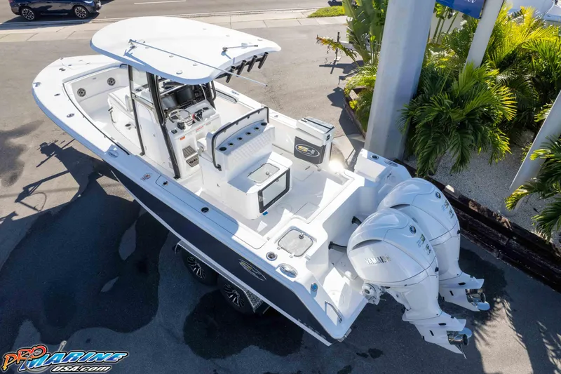 Slide: The Image of 2026 Sea Hunt Gamefish 27 Coffin Box boat with dual engines, docked outdoors. - 18