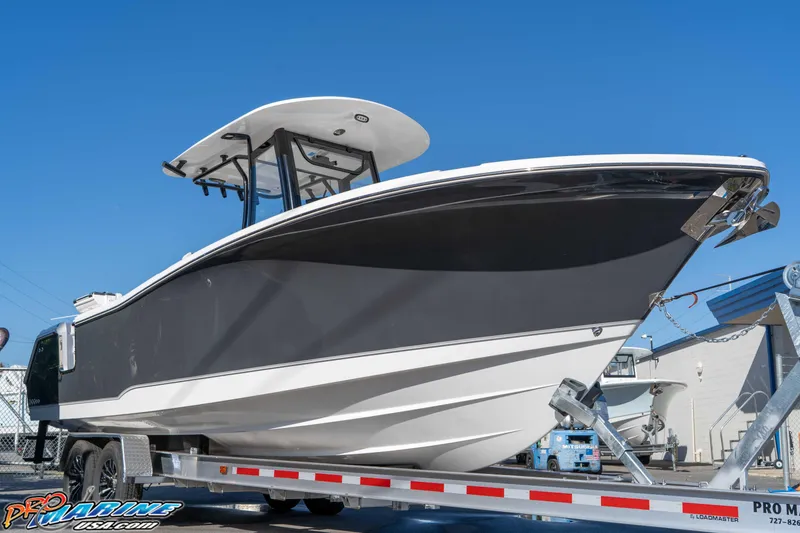 Slide: The Image of 2026 Sea Hunt Gamefish 27 Coffin Box boat on trailer, displayed outdoors. - 19