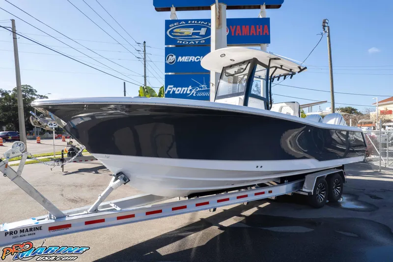 Slide: The Image of 2026 Sea Hunt Gamefish 27 Coffin Box boat on trailer at dealership. - 2