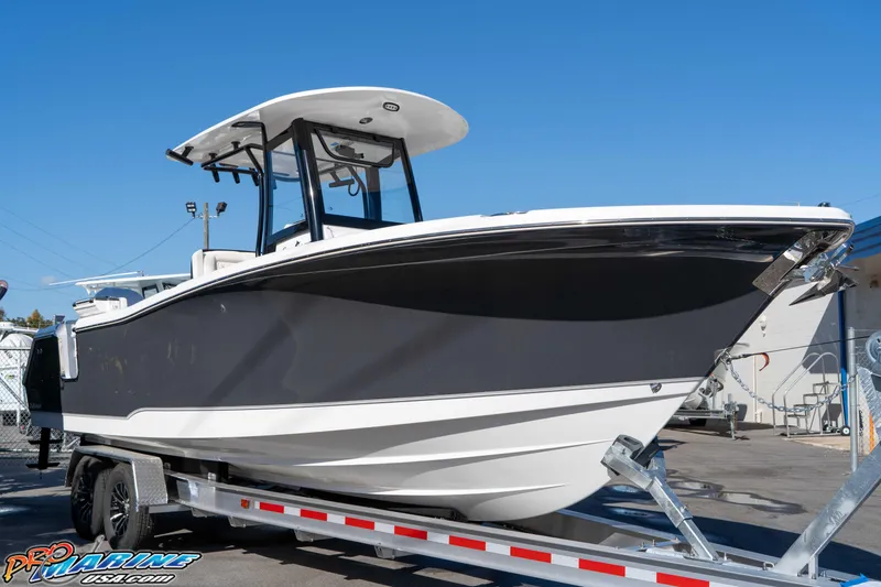 Slide: The Image of 2026 Sea Hunt Gamefish 27 Coffin Box boat on trailer, sleek design, outdoor display. - 21