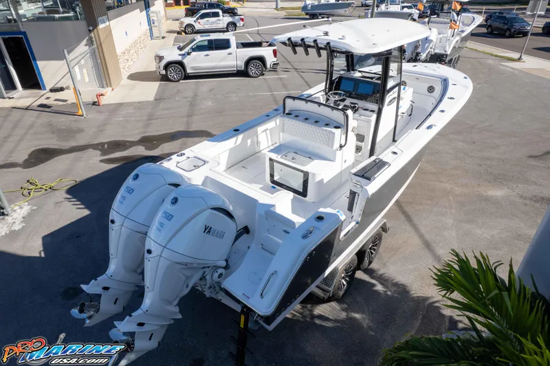 Slide: The Image of 2026 Sea Hunt Gamefish 27 Coffin Box boat with dual Yamaha engines at dealership. - 24