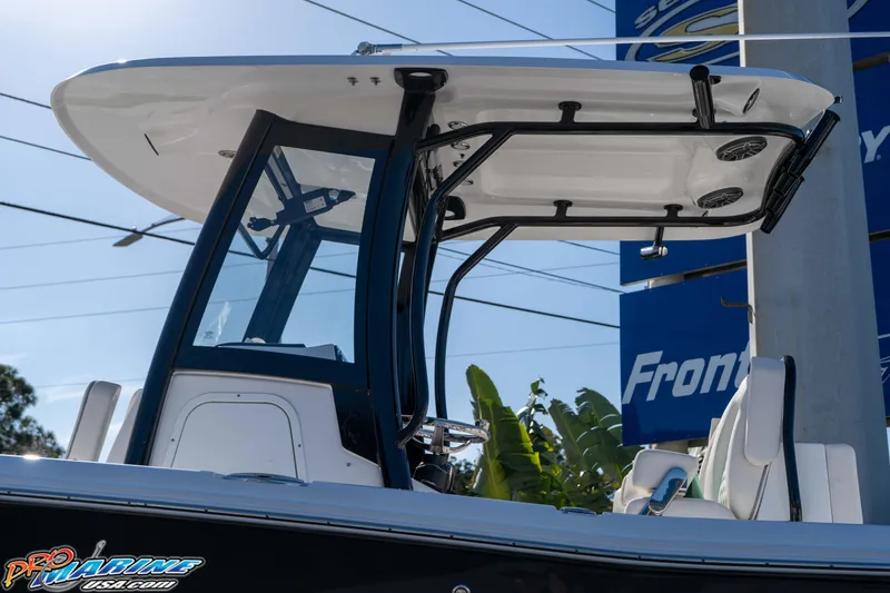 Slide: The Image of 2026 Sea Hunt Gamefish 27 Coffin Box boat with T-top and seating, displayed outdoors. - 25