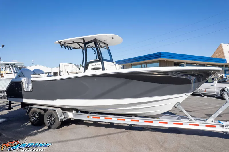 Slide: The Image of 2026 Sea Hunt Gamefish 27 Coffin Box boat on trailer, parked outdoors. - 28