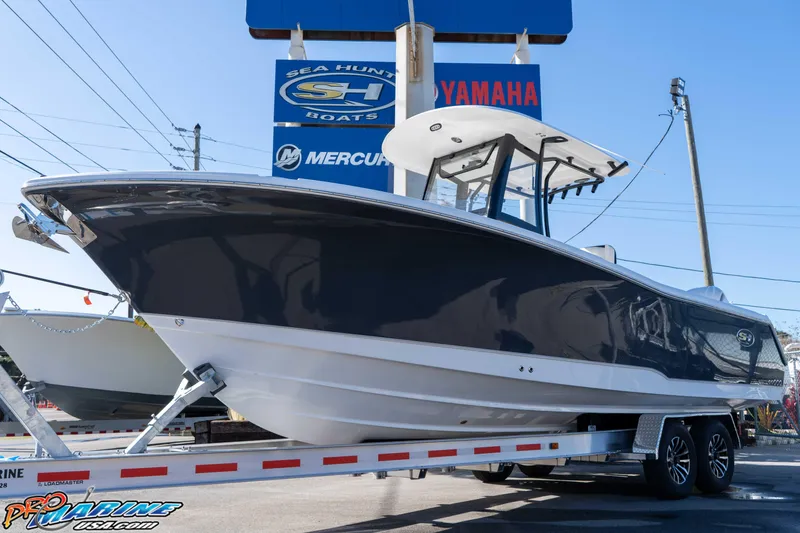 Slide: The Image of 2026 Sea Hunt Gamefish 27 Coffin Box boat on trailer at dealership. - 3
