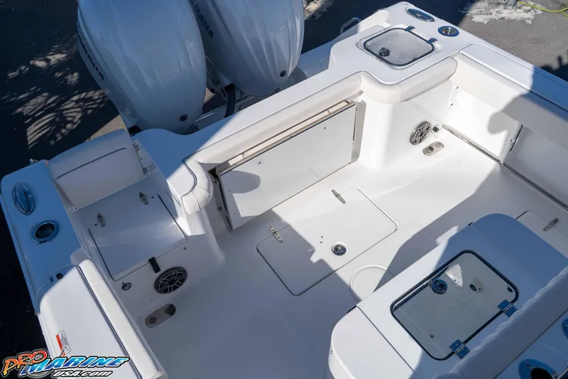 Slide: The Image of 2026 Sea Hunt Gamefish 27 Coffin Box boat interior with storage and seating features. - 33