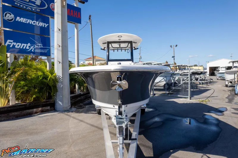 Slide: The Image of 2026 Sea Hunt Gamefish 27 Coffin Box boat displayed at dealership, sunny day. - 34