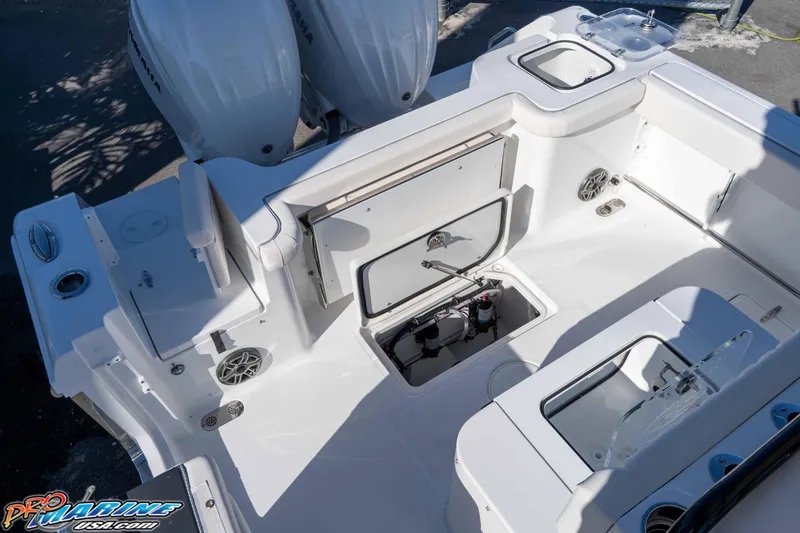 Slide: The Image of 2026 Sea Hunt Gamefish 27 Coffin Box boat interior with storage compartments and dual engines. - 35