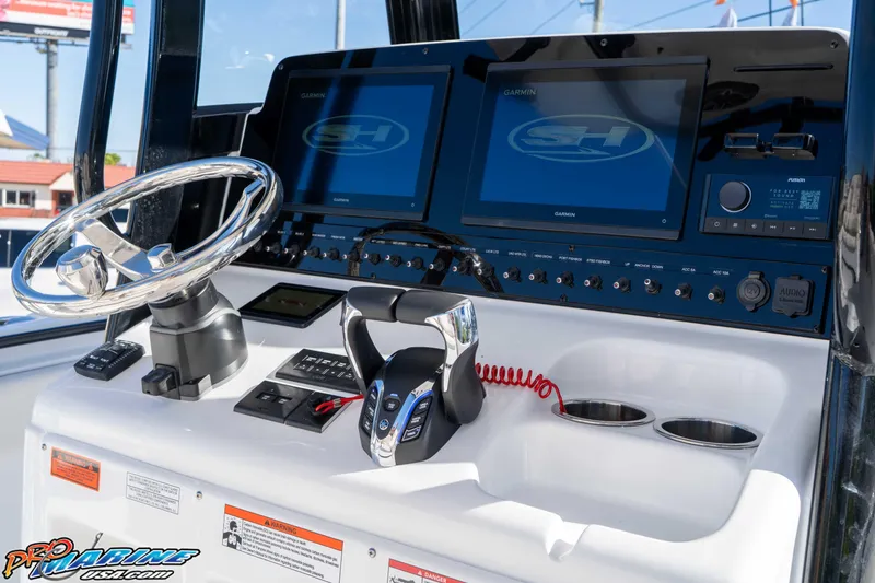 Slide: The Image of 2026 Sea Hunt Gamefish 27 Coffin Box dashboard with steering wheel and Garmin displays. - 47