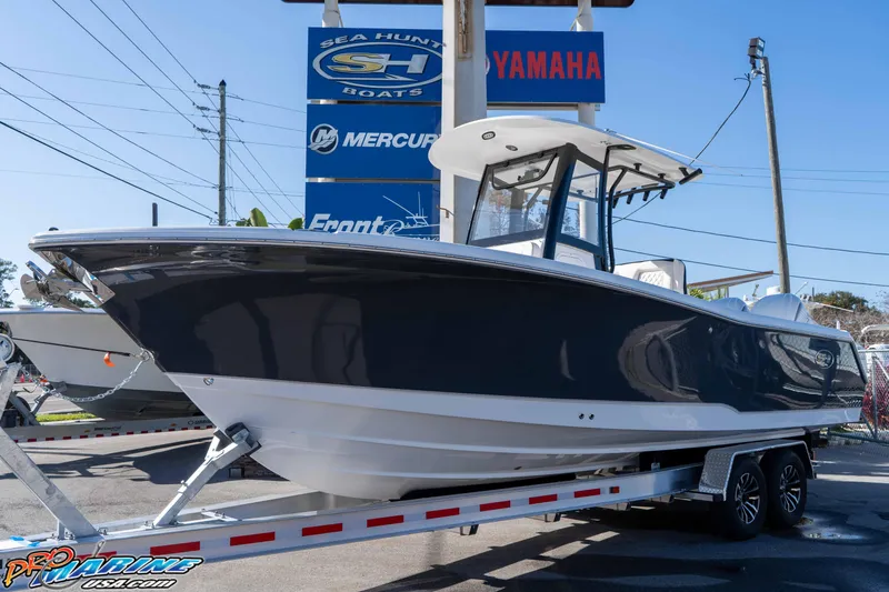 Slide: The Image of 2026 Sea Hunt Gamefish 27 Coffin Box boat on trailer at dealership. - 5