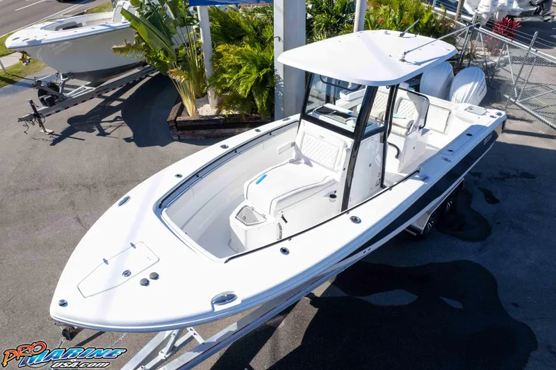 Slide: The Image of 2026 Sea Hunt Gamefish 27 Coffin Box boat displayed outdoors, showcasing sleek design and spacious deck. - 6