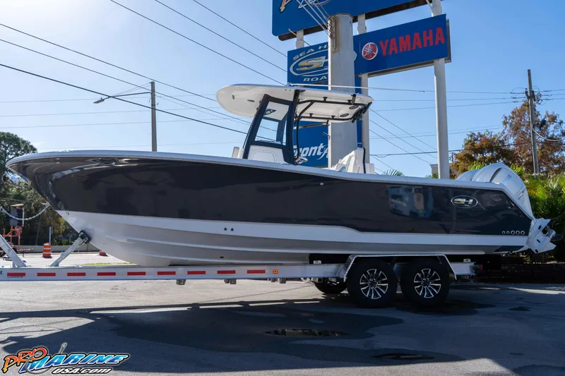 Slide: The Image of 2026 Sea Hunt Gamefish 27 Coffin Box boat on trailer, displayed outdoors. - 7