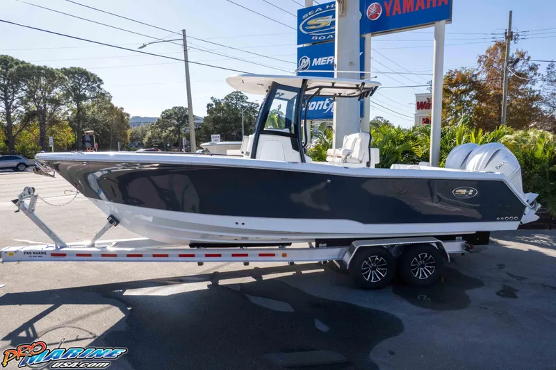 Slide: The Image of 2026 Sea Hunt Gamefish 27 Coffin Box boat on trailer at dealership. - 8