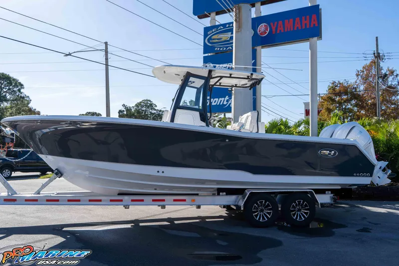 Slide: The Image of 2026 Sea Hunt Gamefish 27 Coffin Box boat on trailer at dealership. - 9