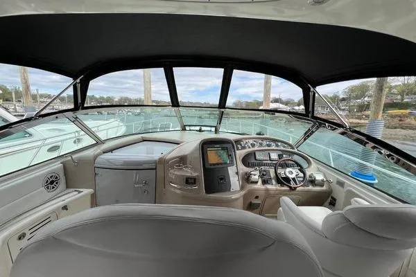 Slide: The Image of Interior view of 2003 Sea Ray 410 Sundancer yacht cockpit with steering wheel and controls. - 10