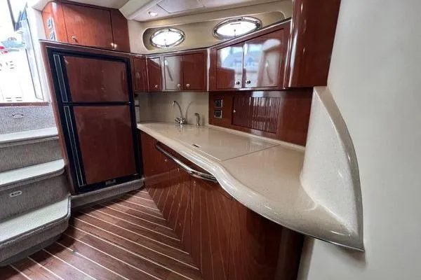 Slide: The Image of Luxurious 2003 Sea Ray 410 Sundancer yacht interior with sleek kitchen design. - 16