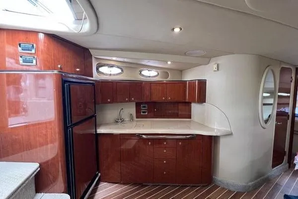 Slide: The Image of Luxurious interior of 2003 Sea Ray 410 Sundancer yacht with modern kitchen amenities. - 17