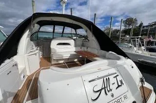 Slide: The Image of 2003 Sea Ray 410 Sundancer yacht docked, featuring spacious deck and seating area. - 2