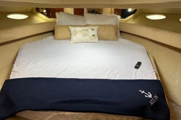 Slide: The Image of Luxurious bedroom interior of 2003 Sea Ray 410 Sundancer yacht with cozy bedding. - 21
