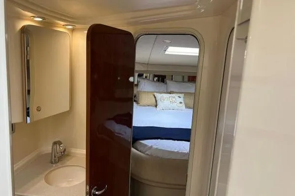 Slide: The Image of Interior of 2003 Sea Ray 410 Sundancer yacht showing bathroom and cozy bedroom. - 26