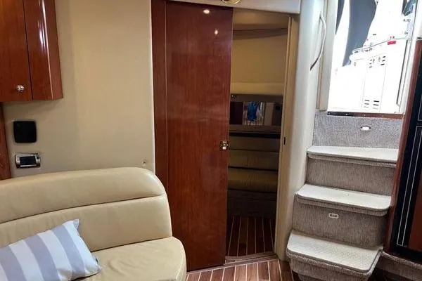 Slide: The Image of Interior of 2003 Sea Ray 410 Sundancer yacht with beige seating and wooden accents. - 27