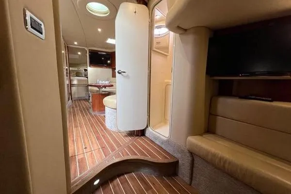 Slide: The Image of Interior of 2003 Sea Ray 410 Sundancer yacht with wood flooring and modern amenities. - 31