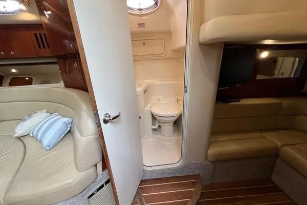 Slide: The Image of 2003 Sea Ray 410 Sundancer interior with bathroom, seating, and wood accents. - 32