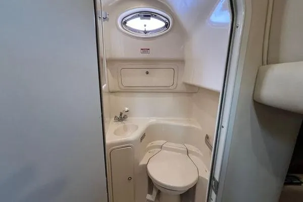 Slide: The Image of Compact bathroom in 2003 Sea Ray 410 Sundancer yacht with sink and toilet. - 33