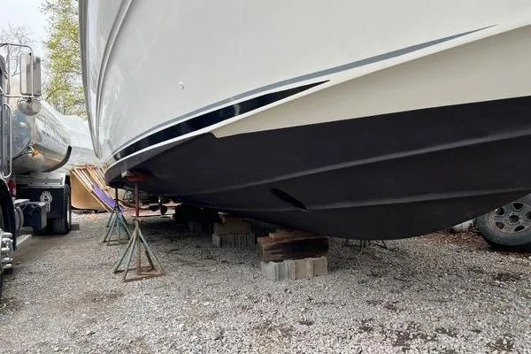 Slide: The Image of 2003 Sea Ray 410 Sundancer boat on stands, side view, outdoors. - 38