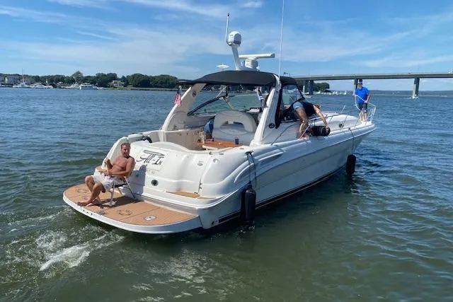 Slide: The Image of 2003 Sea Ray 410 Sundancer yacht cruising on a sunny day with passengers onboard. - 40