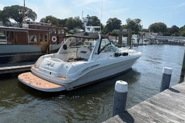 Slide: The Image of 2003 Sea Ray 410 Sundancer yacht docked at a marina on a sunny day. - 42