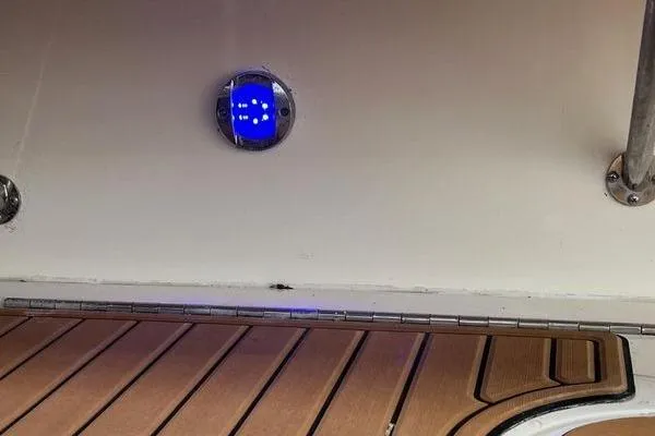 Slide: The Image of 2003 Sea Ray 410 Sundancer interior with wooden flooring and blue LED light. - 7