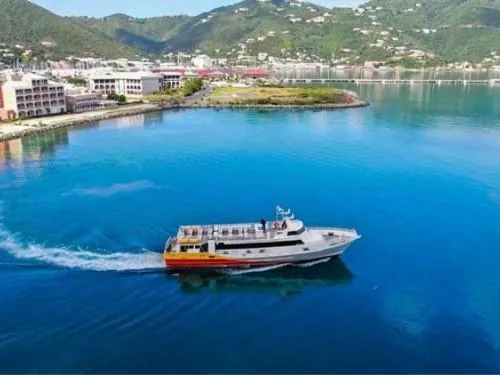 Slide: The Image of High-speed passenger ferry by Midship Marine, 1981, cruising in scenic coastal waters. - 2