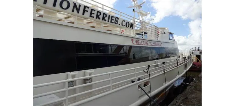 Slide: The Image of High-speed passenger ferry by Midship Marine, 1981, docked at a harbor. - 6