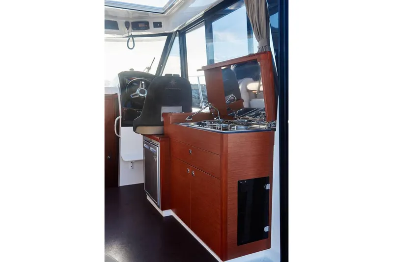 Slide: The Image of Manufacturer Provided Image: 2019 Jeanneau NC 895 boat interior with kitchen and helm station. - 2