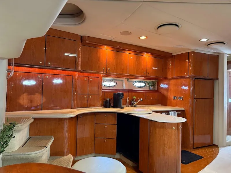 Slide: The Image of Luxurious interior of 2000 Sea Ray 510 Sundancer yacht with polished wood cabinetry. - 16