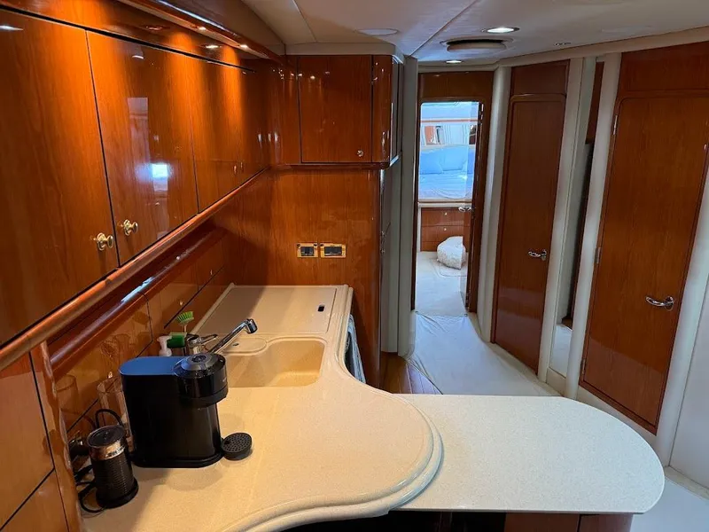 Slide: The Image of Luxurious interior of 2000 Sea Ray 510 Sundancer yacht with polished wood cabinetry. - 18