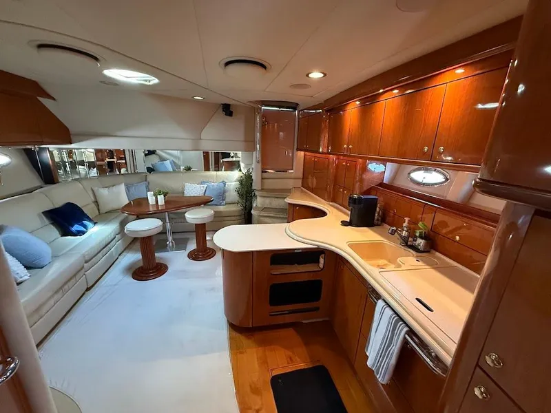 Slide: The Image of Luxurious interior of 2000 Sea Ray 510 Sundancer yacht with elegant seating and modern kitchen. - 19