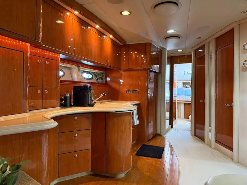 Slide: The Image of Luxurious interior of a 2000 Sea Ray 510 Sundancer yacht with polished wood cabinetry. - 22