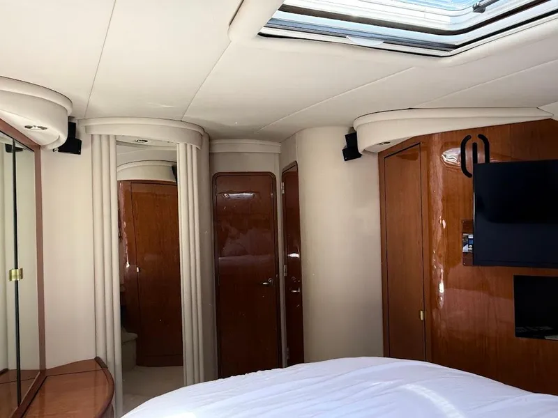 Slide: The Image of Interior of 2000 Sea Ray 510 Sundancer yacht, featuring wood paneling and a skylight. - 29