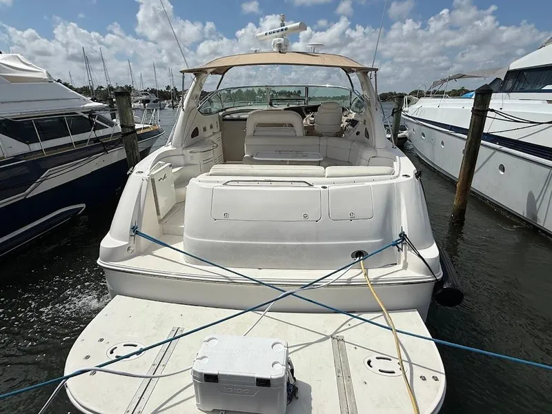 Slide: The Image of 2000 Sea Ray 510 Sundancer yacht docked at marina under blue sky. - 3