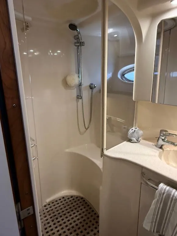 Slide: The Image of 2000 Sea Ray 510 Sundancer bathroom with shower, sink, and porthole window. - 30